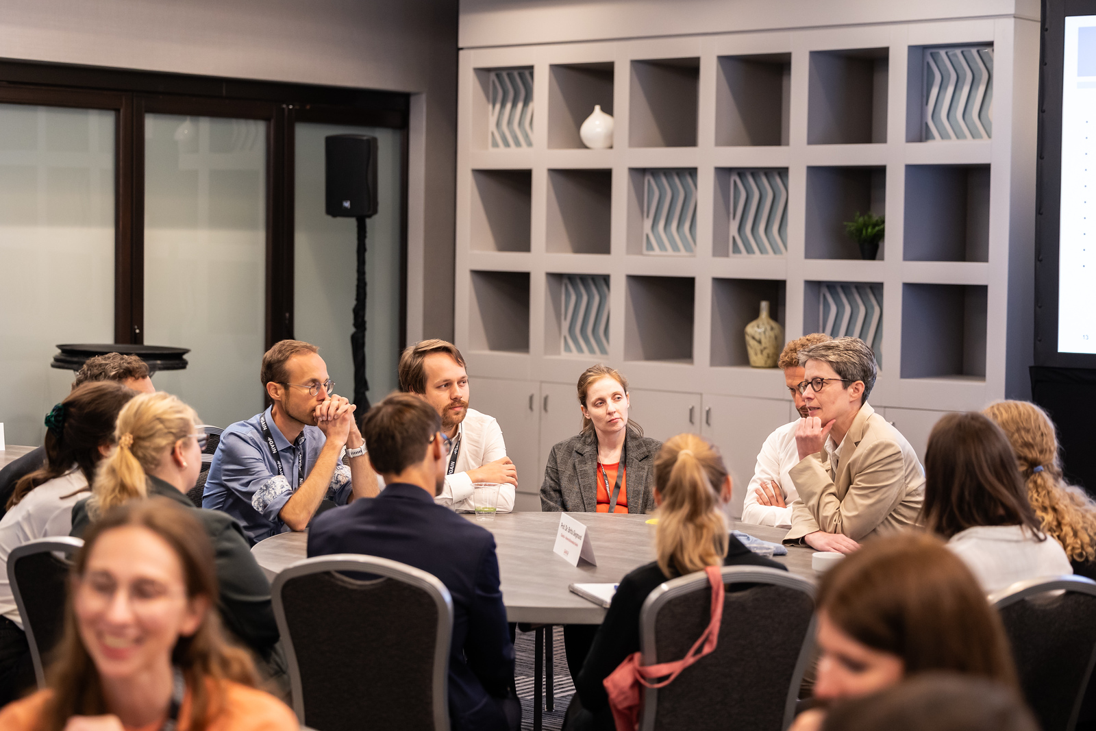 Several people sit at a table and talk